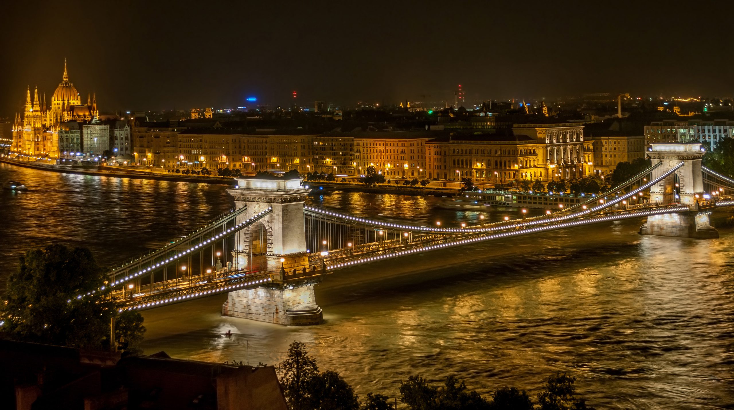 View of Budapest at night from Buda Castle. The Chain Bridge can be seen in the foreground.