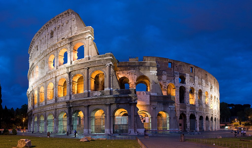 The Colosseum is the largest Roman Amphitheater ever built, and is located in Rome, Italy.