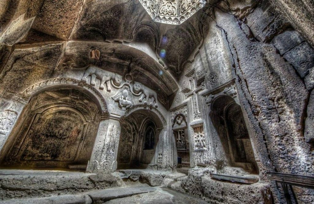 Geghard Monastery is partially carved from the rock of the adjacent hillside, making it a great example of Rock Cut Architecture.