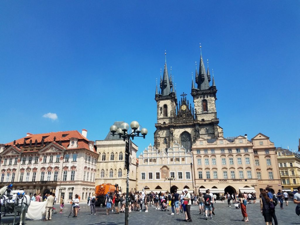 The old town square is a famous site in prague filled with many different styles of architecture 