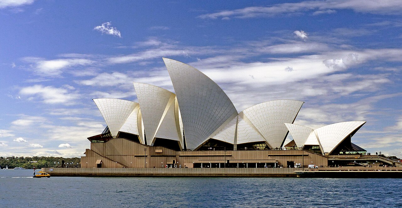 The Sydney Opera House is a large work of modern architecture overlooking Sydney's Harbor. 